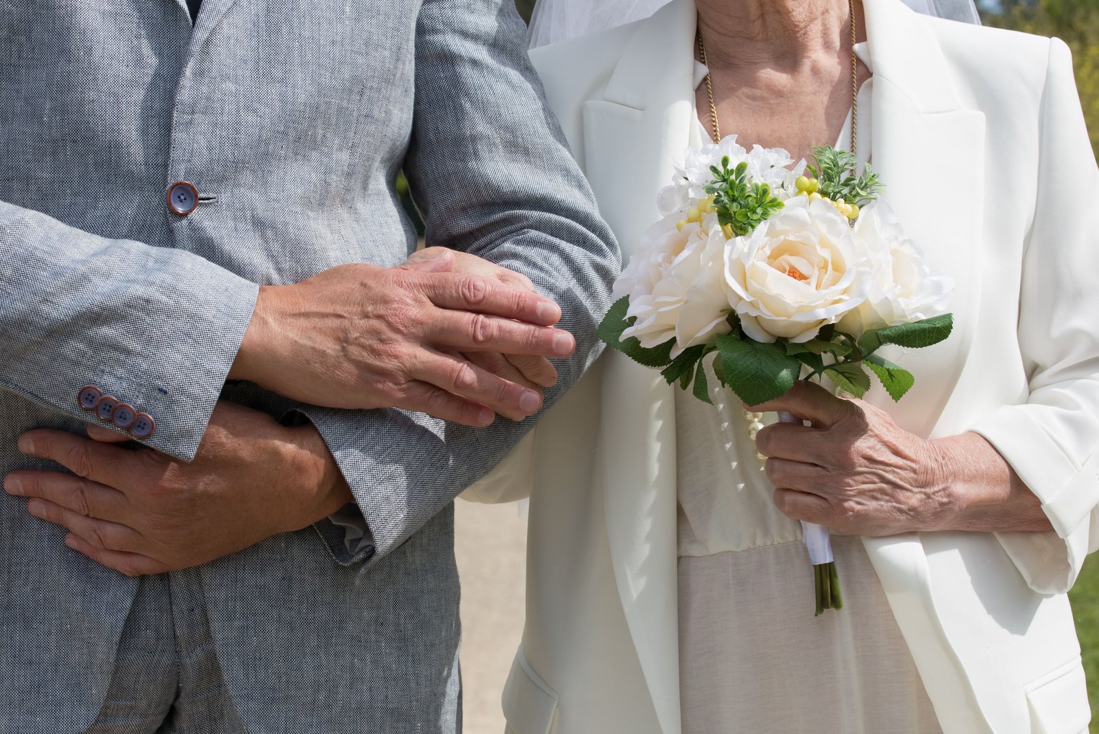 Intimate garden gazebo adorned with blooming flowers for vow renewals